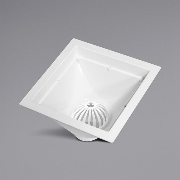 An Endura white square floor sink with a PVC hub.