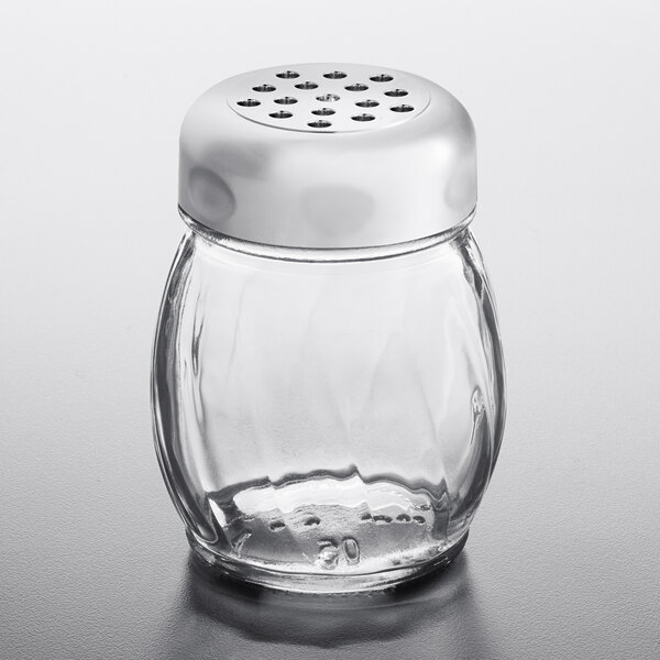 A Tablecraft glass swirl shaker with a chrome plated top on a table.