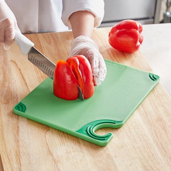 a person cutting a pepper with a knife