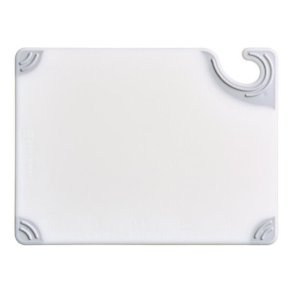 A rectangular white cutting board with gray non-slip corners and a built-in hook for hanging.