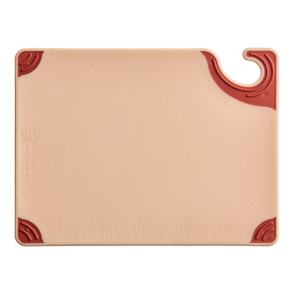 A rectangular brown cutting board with red corner grips and a built-in hanging hook.