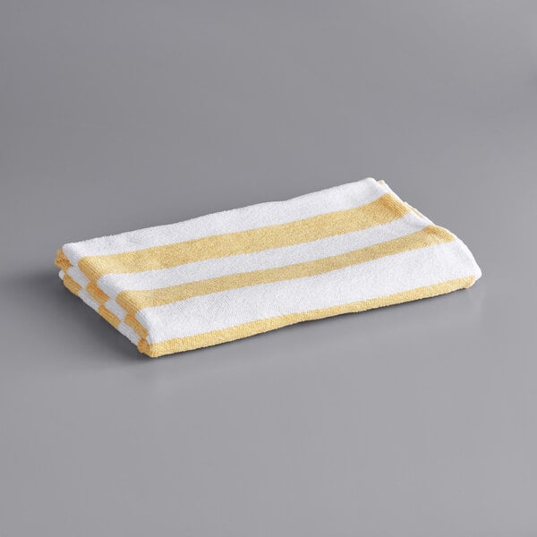 A white and yellow striped Oxford Classic pool towel.