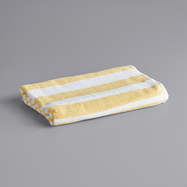 An Oxford yellow and white striped pool towel.