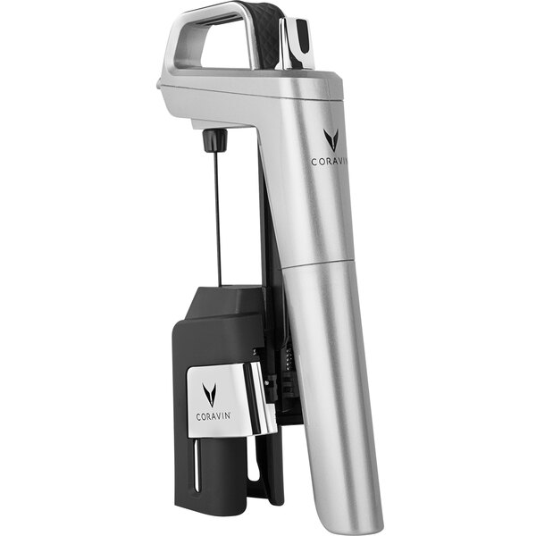 A silver and black Coravin wine opener on a counter next to a bottle.