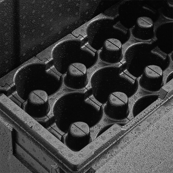 A black Cambro Cam GoBox top loading food pan carrier with cup holders and holes for six small plastic cups.