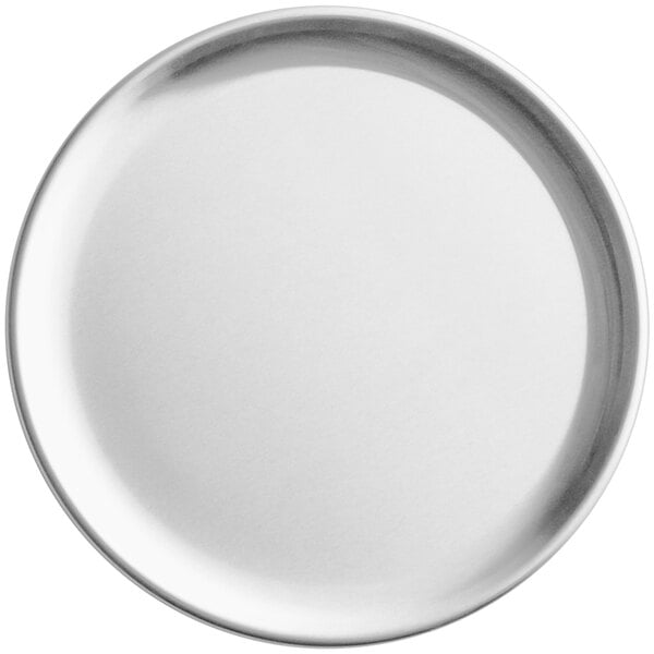 A close-up of a Choice aluminum coupe pizza pan with a white surface.