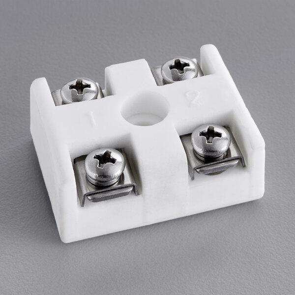 A white plastic ServIt terminal block with screws.