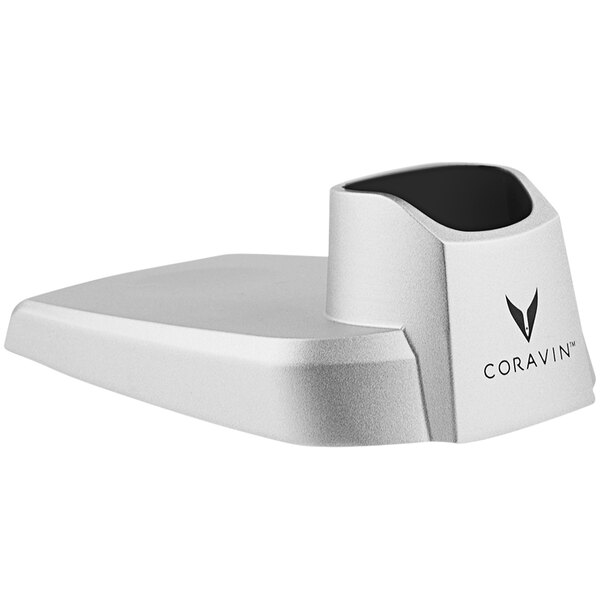A close-up of a Coravin grey wine dispensing system base with white text on it.