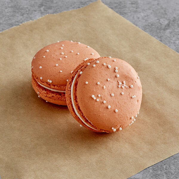 Two Macaron Centrale S'mores macarons on a piece of paper.