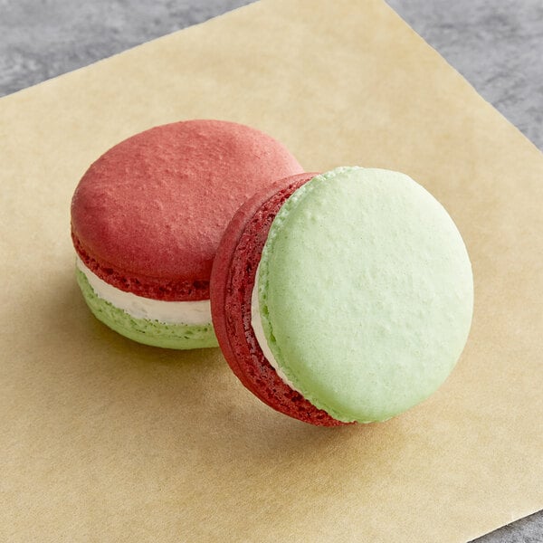 Two Macaron Centrale apple caramel macarons on a napkin.