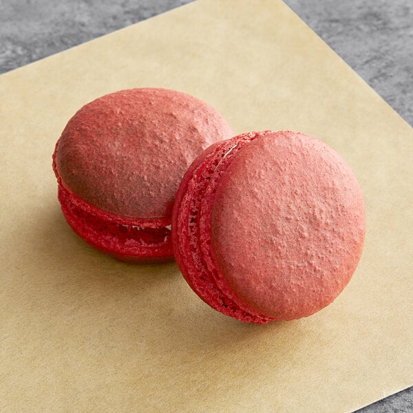 two red cookies on a table