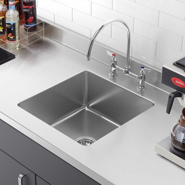 A close-up of a Regency stainless steel fabricated undermount sink bowl.