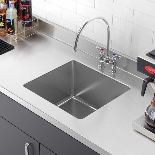 A close-up of a Regency stainless steel fabricated undermount sink bowl.