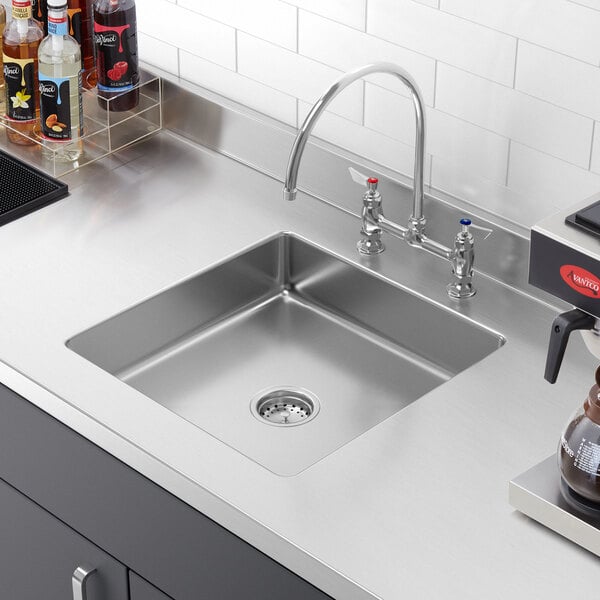 A close-up of a Regency stainless steel fabricated weld-in undermount sink bowl.