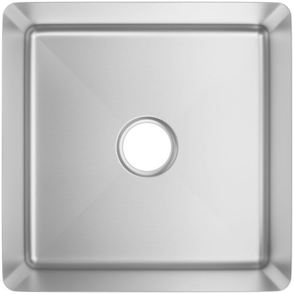 A close-up of a Regency stainless steel fabricated undermount sink bowl with a square hole.