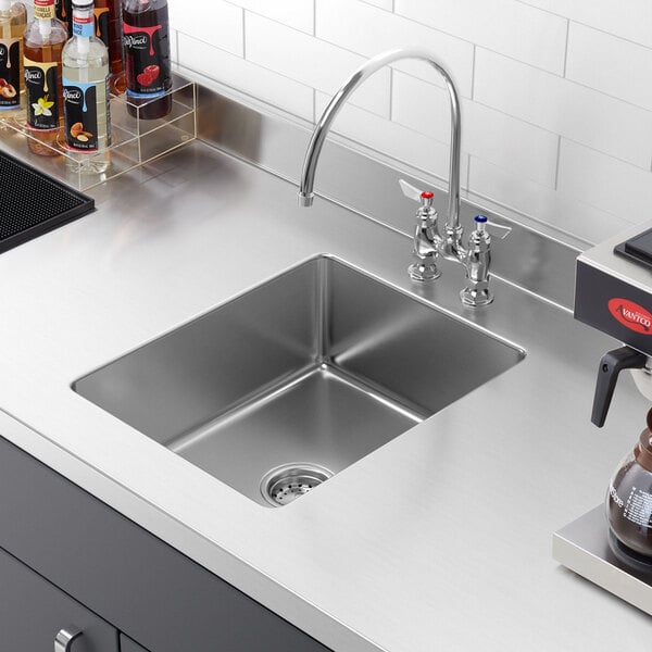 A close-up of a Regency stainless steel undermount sink bowl.