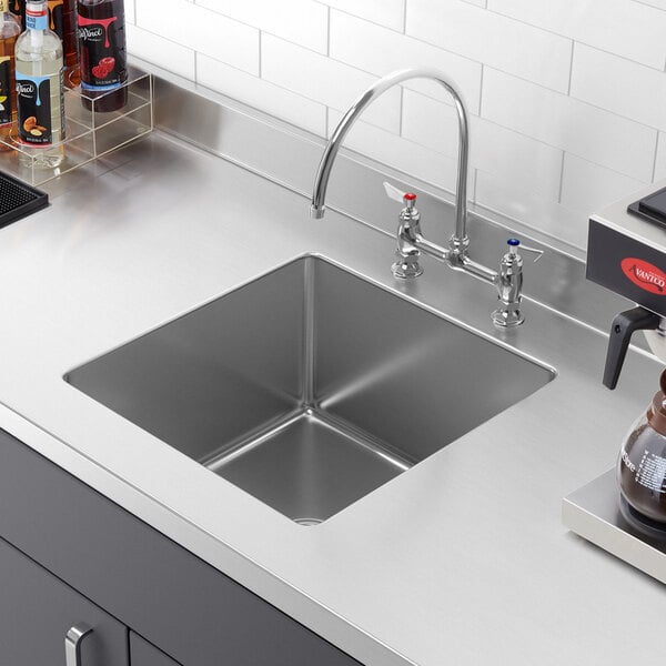 A close-up of a Regency stainless steel fabricated undermount sink bowl.