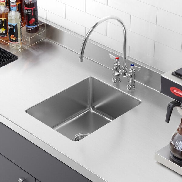 A close-up of a Regency stainless steel undermount sink bowl.