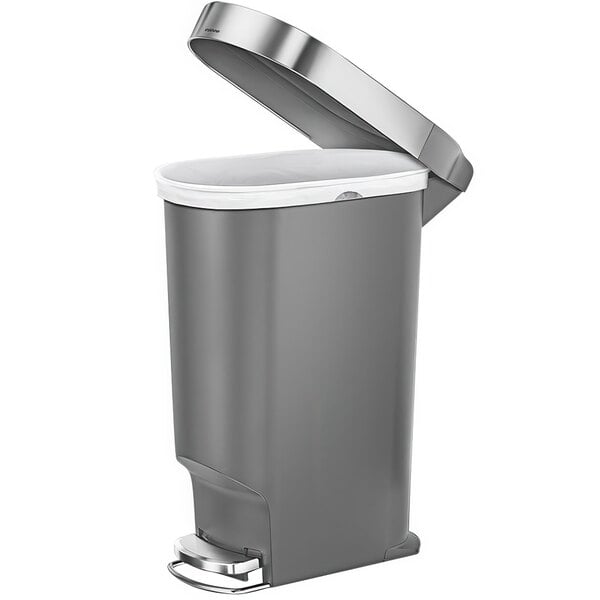A simplehuman grey plastic step-on trash can with lid open.