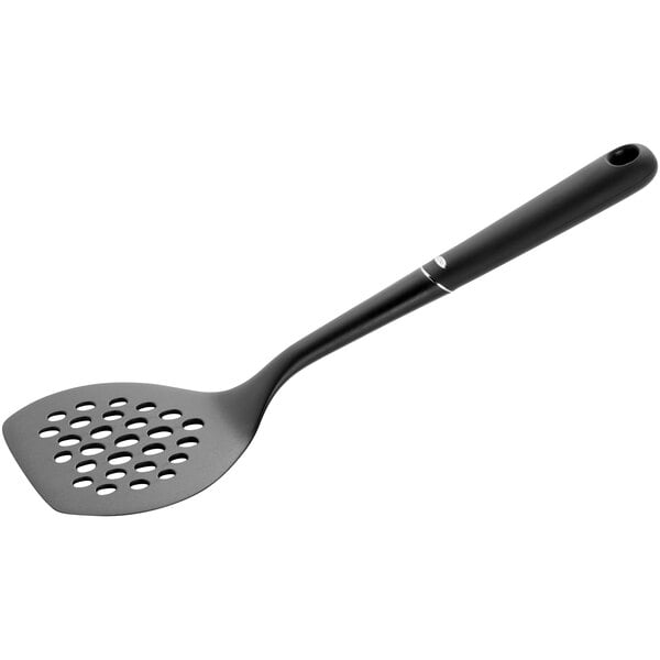 An OXO Good Grips black nylon perforated turner with a handle.