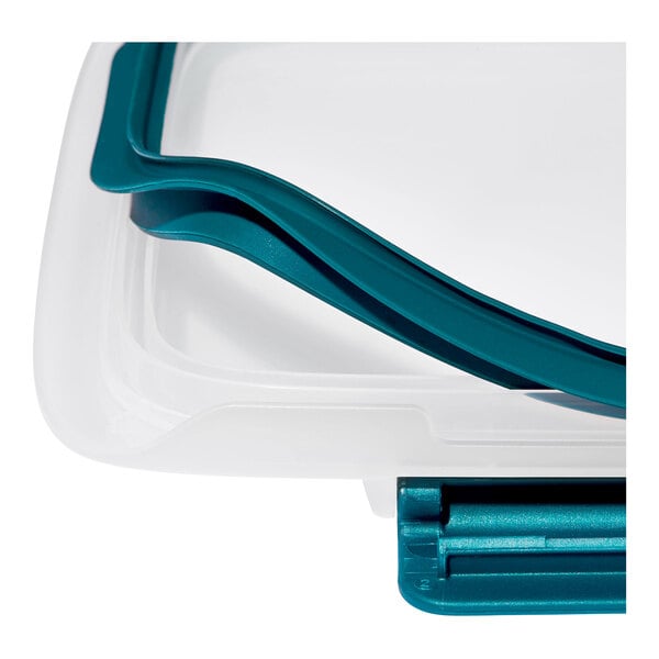 A close-up view of a clear rectangular container with a teal snap-on lid.