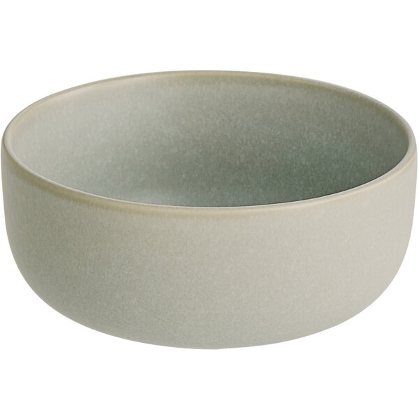 An Acopa Pangea white porcelain bowl with a gray rim.