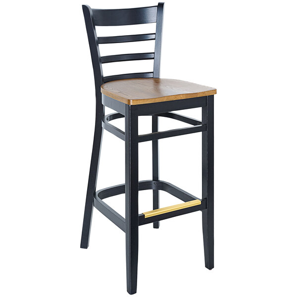 A BFM Seating black beechwood barstool with a wooden seat.