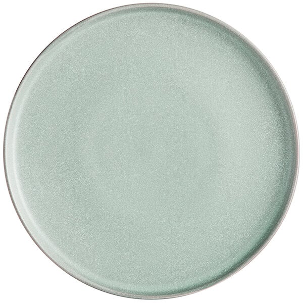 An Acopa Pangea Harbor Blue matte coupe porcelain plate with a white rim on a white background.