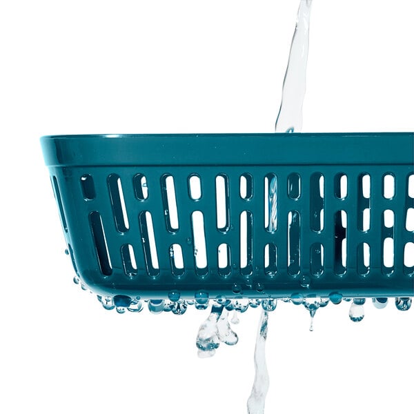 A clear rectangular food storage container with a blue colander inside.
