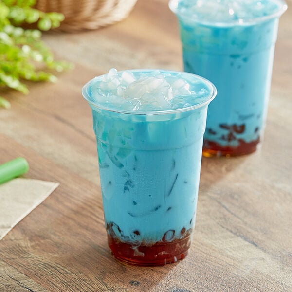 Two cups of blue Fanale Lychee Jelly topping in a plastic cup with a straw.