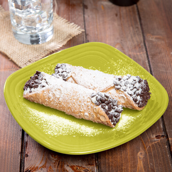 A Fiesta lemongrass square salad plate with two pastries on it.