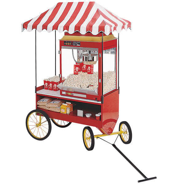 a red and white striped tent with popcorn on wheels