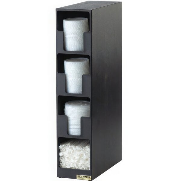 A black San Jamar vertical countertop lid organizer with straw bin holding white plastic lids and straws.