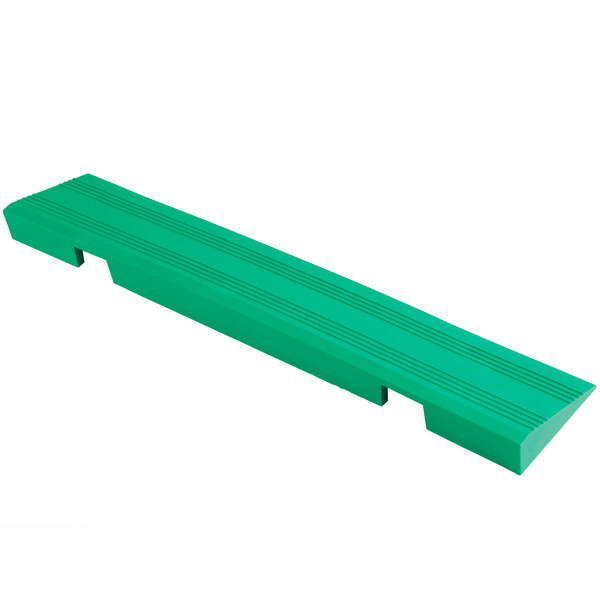 A green rectangular Cactus Mat vinyl edge ramp with holes.