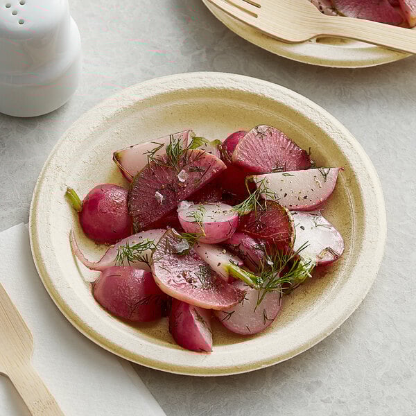 A Tellus Products bagasse plate with radish salad on it.