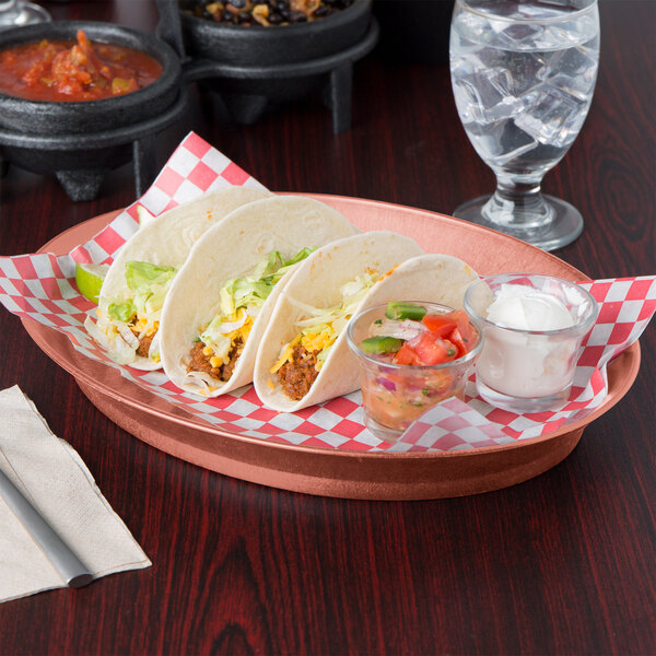 A group of HS Inc. oval deli servers with tacos and salsa on a table in a Mexican restaurant.