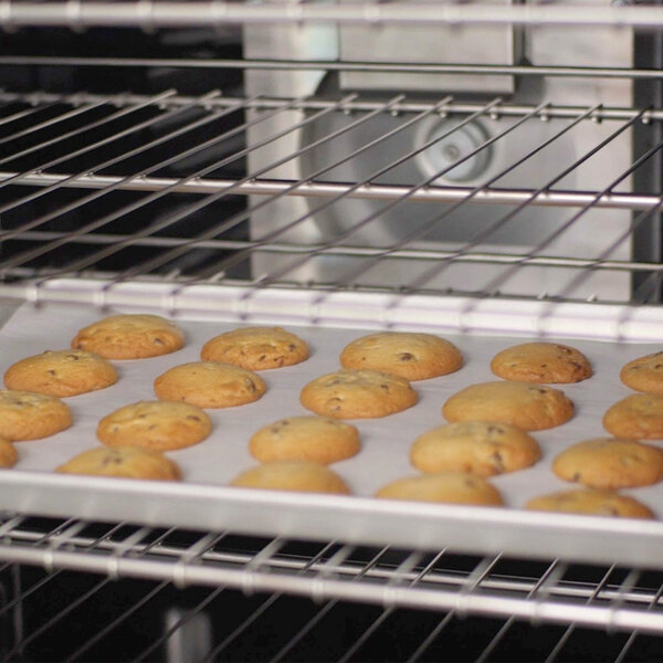 A tray of cookies baking inside an electric convection oven.