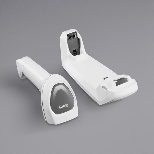 A white Zebra barcode scanner with a black cradle.