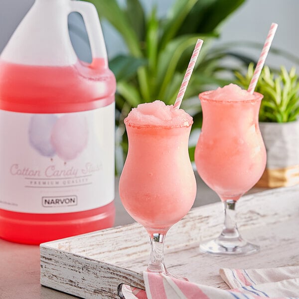 Two glasses of pink Narvon cotton candy slushy with straws.