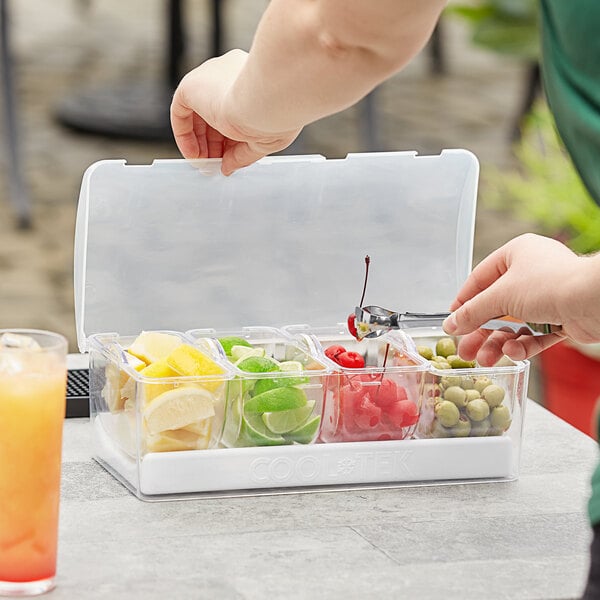 A person putting fruit into a Mr. Bar-B-Q condiment container.