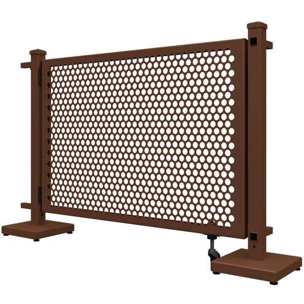 a brown metal fence with holes