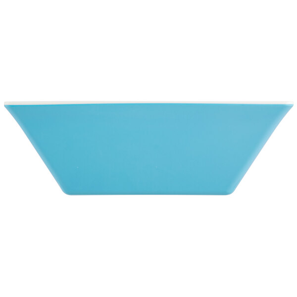 A blue rectangular bowl with white edges.