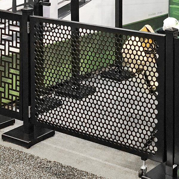 A black metal gate with a circle pattern on it.