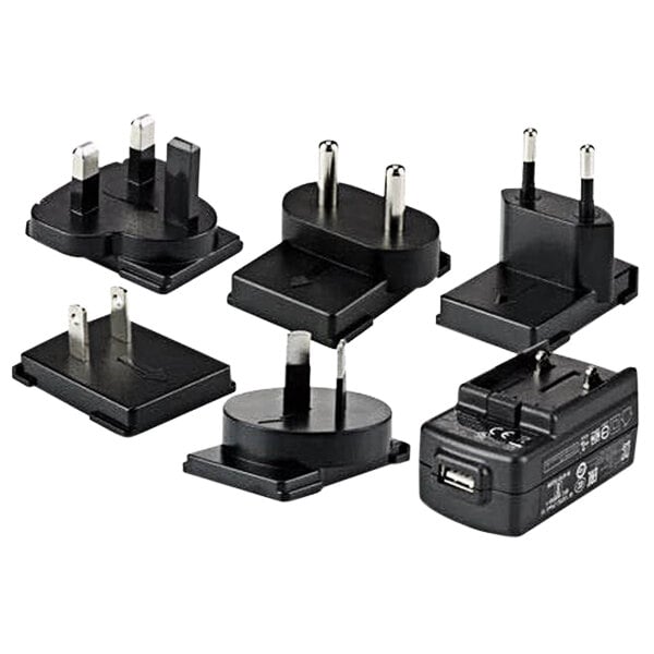 A group of black and white plugs and adapters for Honeywell ScanPal computers.