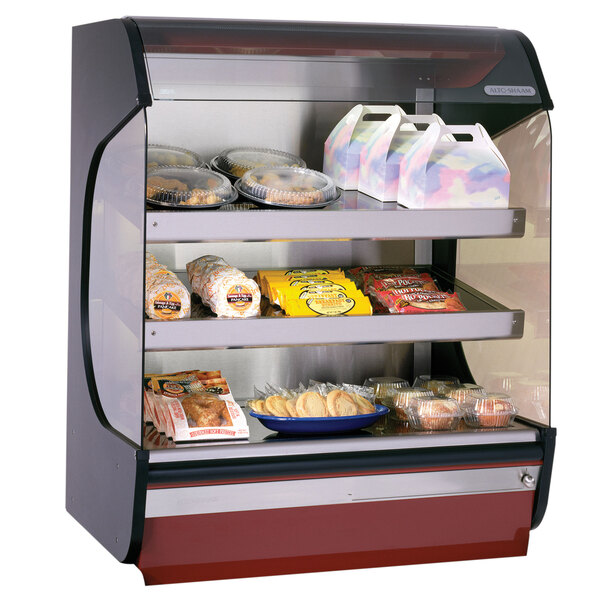 An Alto-Shaam hot food merchandiser display case with food on shelves.