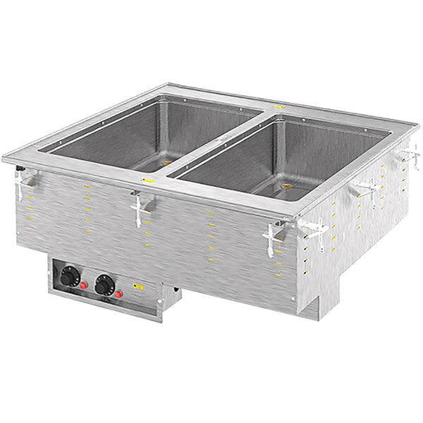 A Vollrath stainless steel drop-in hot food well with two compartments on a counter.