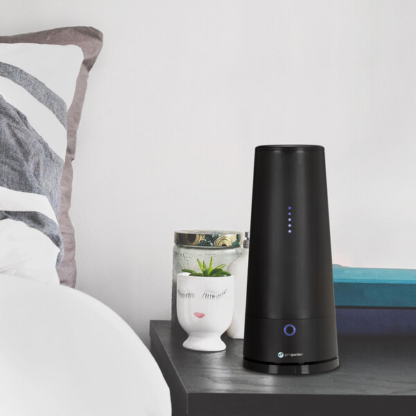 A black Guardian Technologies Germ Guardian air sanitizer on a table.