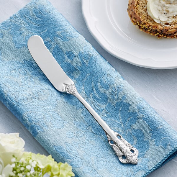 Butter knife on a blue cloth napkin