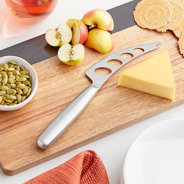 Semi-hard cheese knife on a cheese board