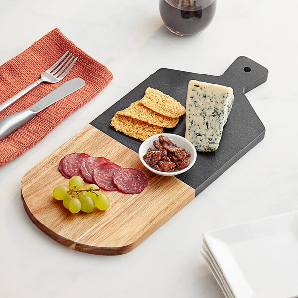 A rectangular cutting board, half wood and half slate